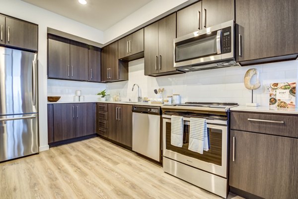 Modern kitchen with stainless steel appliances at The Exchange at Bayfront Apartments