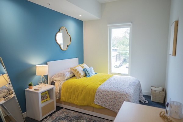 Bedroom featuring modern design and stylish furnishings at Cheatham Street Flats Apartments