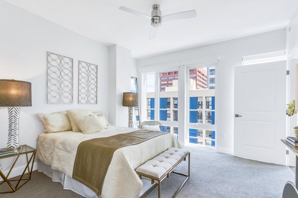 Cozy bedroom featuring modern furnishings at The Fitzgerald Apartments