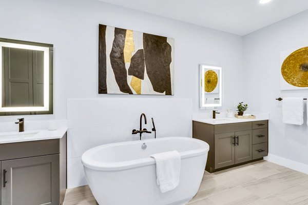Modern bathroom with sleek fixtures and ample storage at The Fitzgerald Apartments