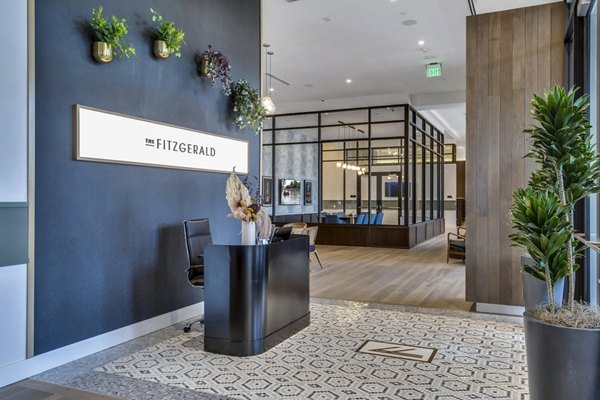 Clubhouse lobby with modern decor and seating area at The Fitzgerald Apartments