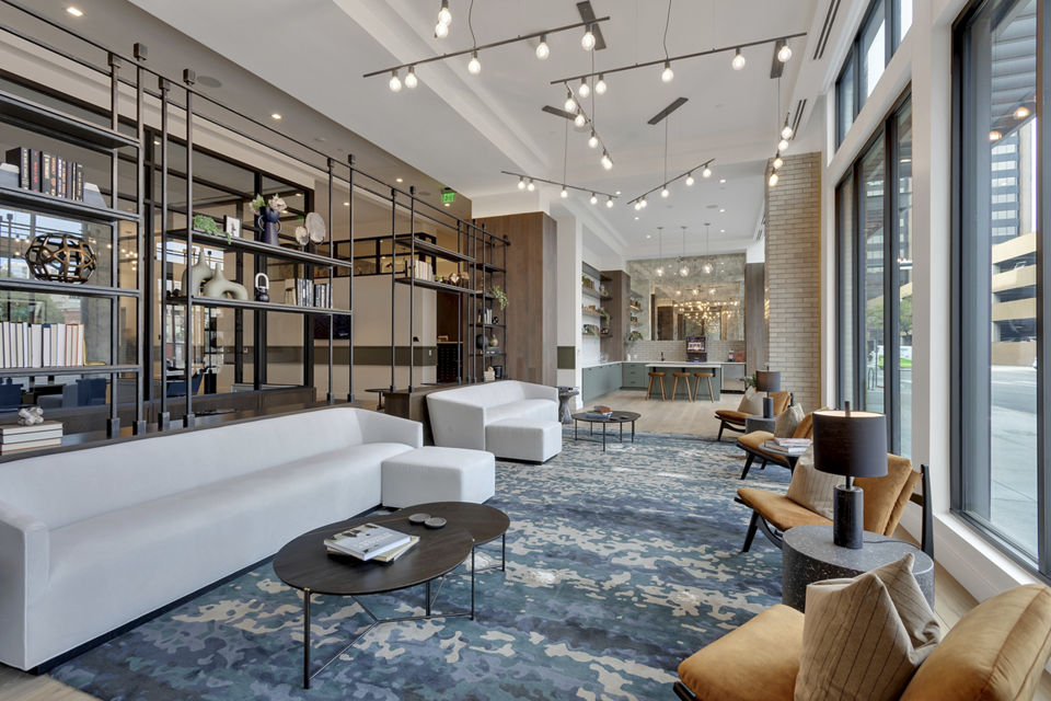 Clubhouse lobby with modern decor and seating area at The Fitzgerald Apartments