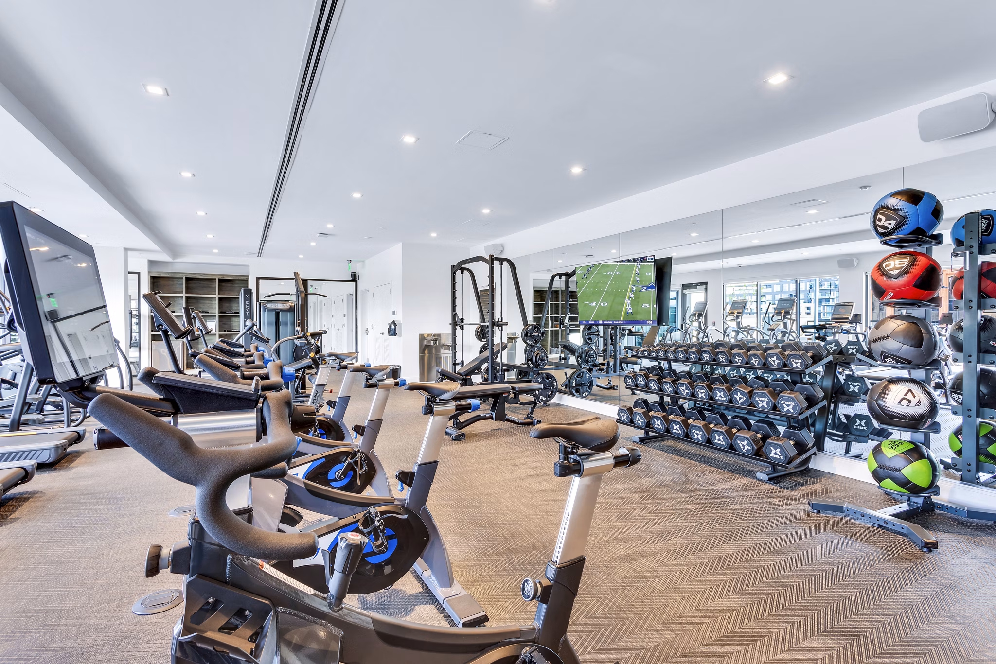 Fitness center with modern equipment at The Fitzgerald Apartments, offering a spacious workout space tailored for tenant wellness