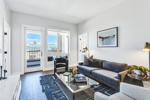 Spacious living room with modern furnishings at The Fitzgerald Apartments