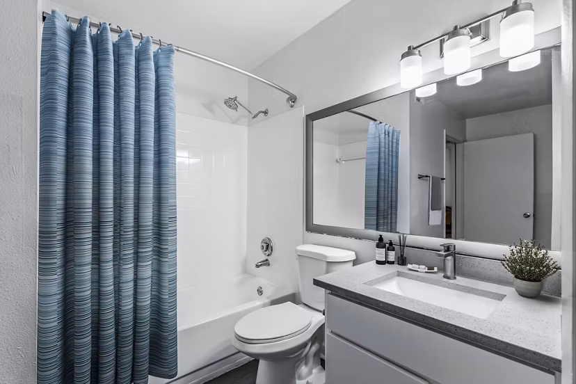 Modern bathroom with elegant fixtures and large mirror at Avana Lakeview Apartments