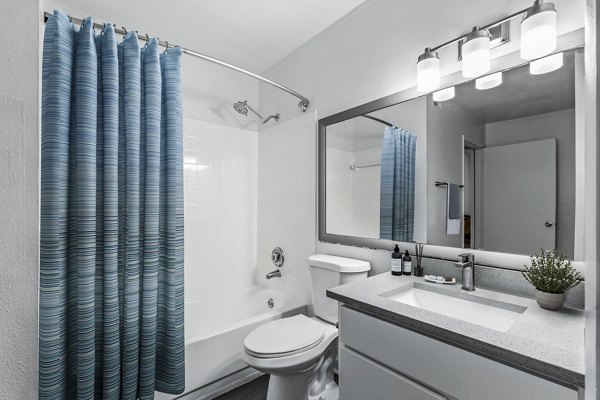 Modern bathroom with elegant fixtures and large mirror at Avana Lakeview Apartments