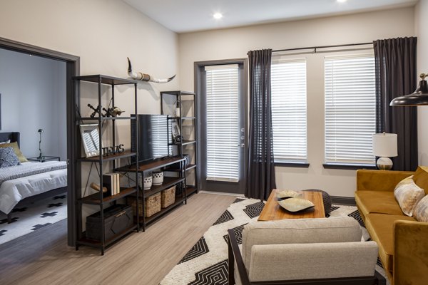 Modern living room with sleek furniture and natural light at Westhouse Apartment Flats