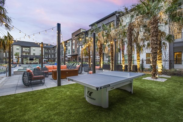 Outdoor sport court at Westhouse Apartment Flats with basketball hoops and seating area