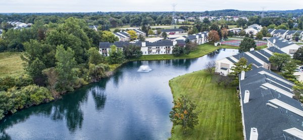 Hidden Lakes Apartments: Scenic waterfront view featuring lush greenery and serene lake atmosphere