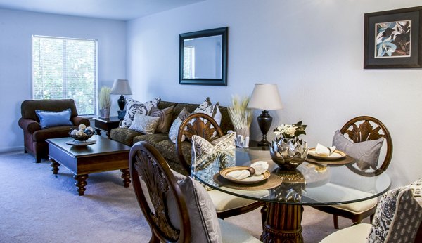Dining area with elegant chandelier and modern furniture in Hidden Lakes Apartments