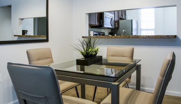 Dining room featuring elegant decor and large windows in Hidden Lakes Apartments