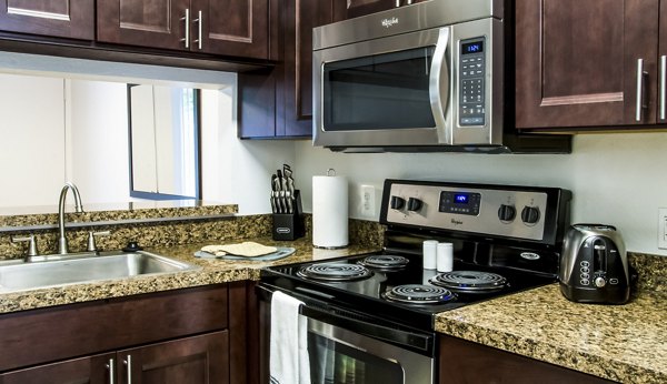 Spacious kitchen with modern appliances at Hidden Lakes Apartments, ideal for cooking and entertaining in luxury