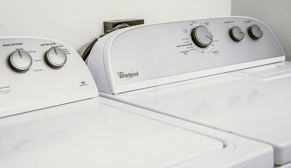 Laundry room with modern appliances at Hidden Lakes Apartments