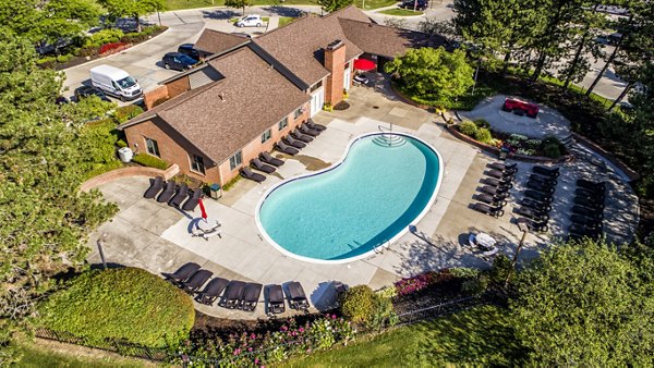 Spacious outdoor pool at Laurel Valley Apartments with sun loungers and lush landscaping