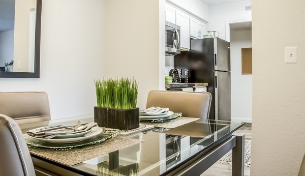 Dining room featuring elegant dining set and modern lighting at Oak Hill Apartments