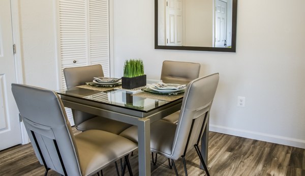 Dining room with elegant modern design in Oak Hill Apartments, featuring sleek furniture and ambient lighting for a luxury living experience