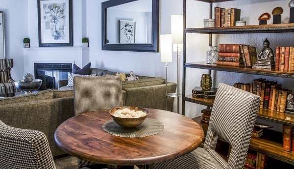 Dining room with elegant furnishings at Oak Hill Apartments, featuring a modern chandelier and stylish dining table setup