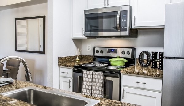 Oak Hill Apartments: Modern kitchen with stainless steel appliances and granite countertops