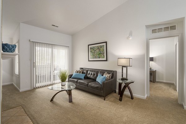 Inviting living room with modern decor and ample natural light at Shoal Creek Apartments