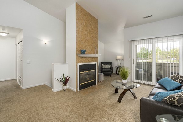 Spacious living room featuring modern decor and natural light in Shoal Creek Apartments
