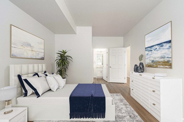 Cozy bedroom with modern decor at Woodland Meadows Apartments, offering luxury living in a serene environment