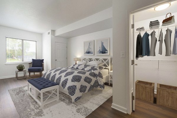 Spacious bedroom featuring large windows and modern decor at Woodland Meadows Apartments