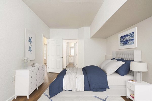 Cozy bedroom with queen bed and stylish decor in Woodland Meadows Apartments