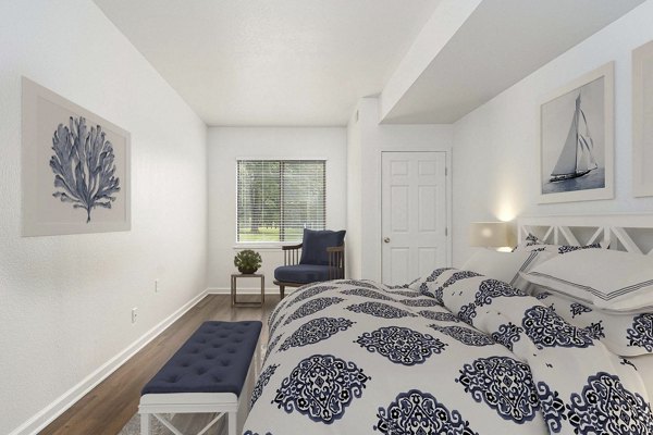 Cozy bedroom with modern furnishings at Woodland Meadows Apartments
