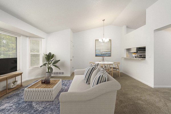 Living room featuring modern furnishings and large windows at Woodland Meadows Apartments