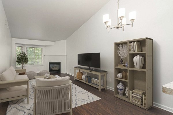 Spacious living room featuring modern furnishings and large windows in Woodland Meadows Apartments