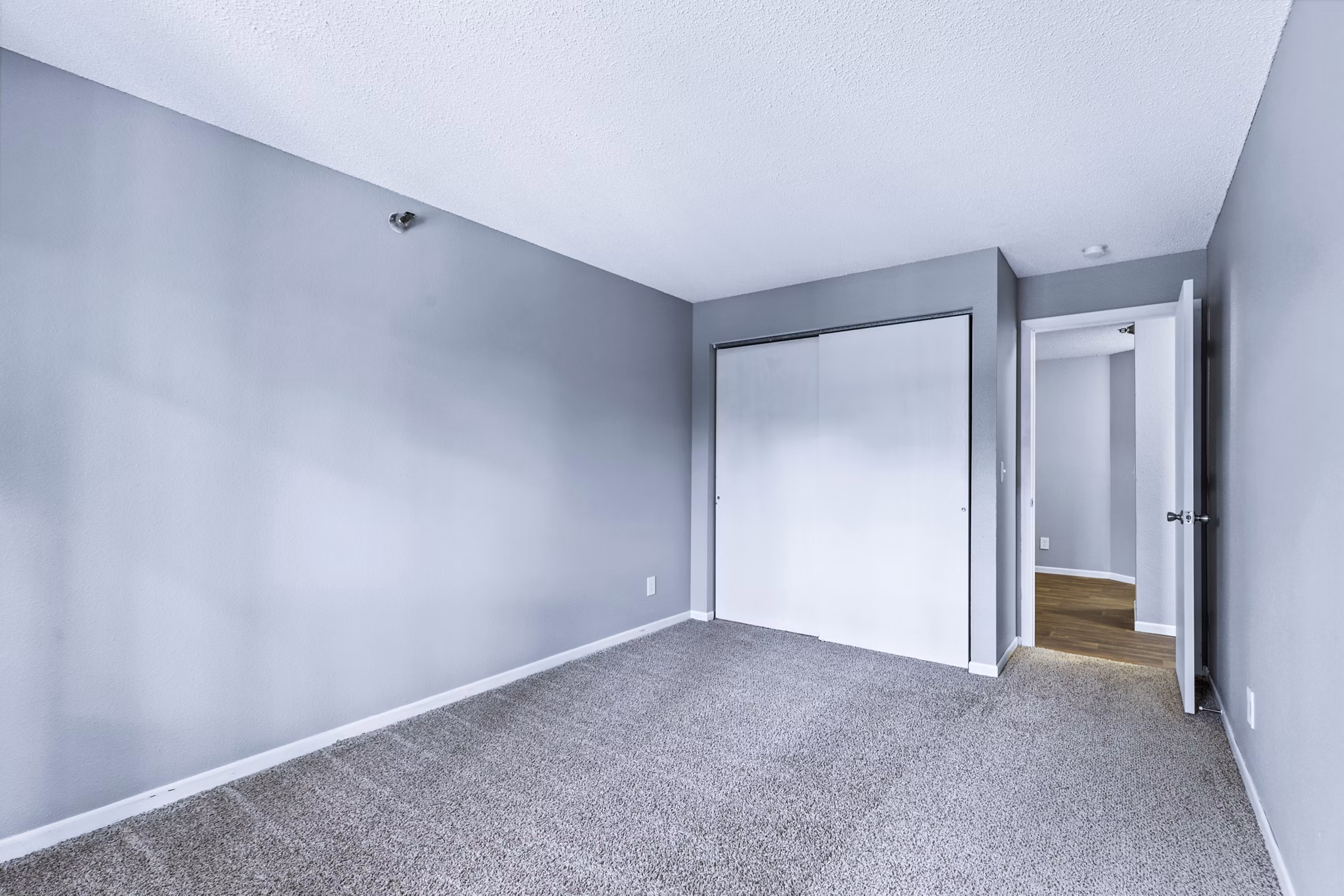 Luxurious bedroom with elegant decor at Avana West Park Apartments, featuring plush bedding and stylish furniture