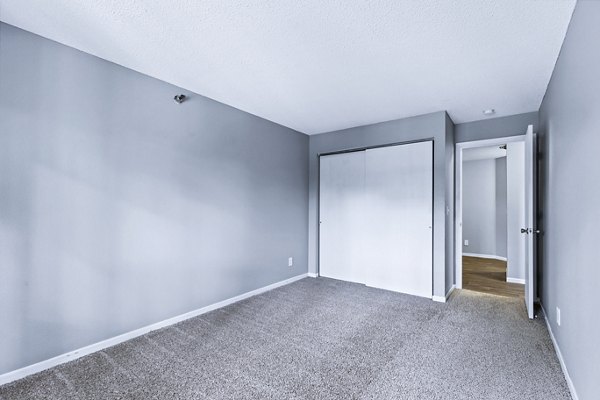 Luxurious bedroom with elegant decor at Avana West Park Apartments, featuring plush bedding and stylish furniture
