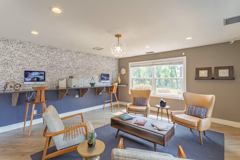 Modern clubhouse featuring cozy seating and gaming area at Avana West Park Apartments