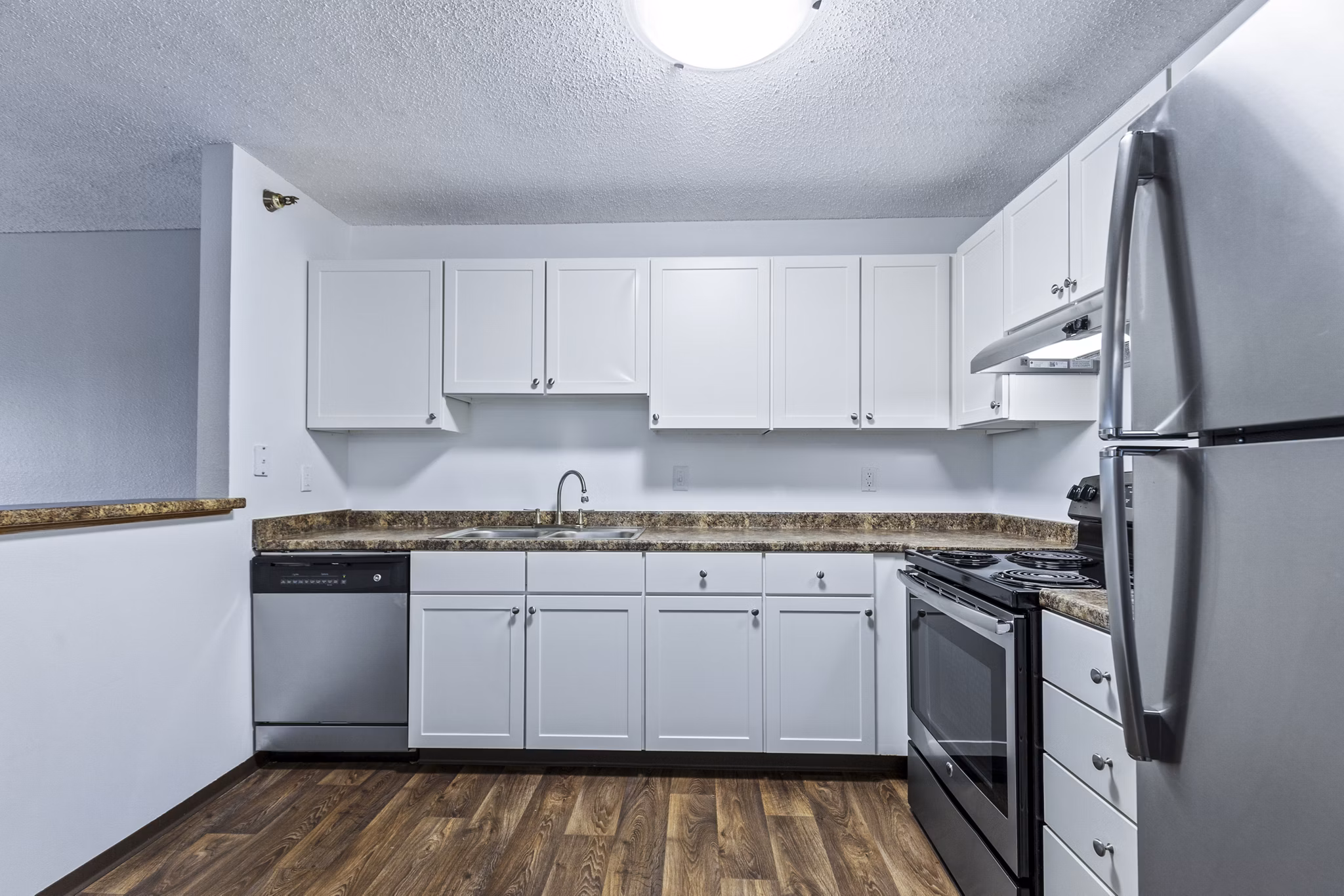 Modern kitchen with stainless steel appliances in Avana West Park Apartments