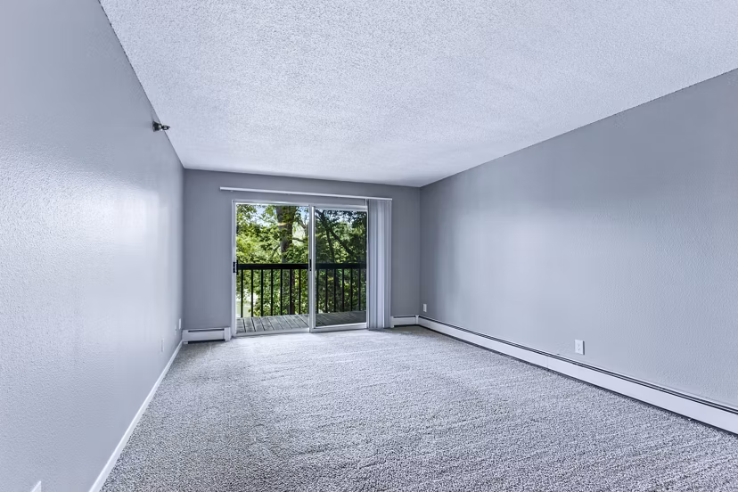Spacious living room with modern decor and large windows in Avana West Park Apartments