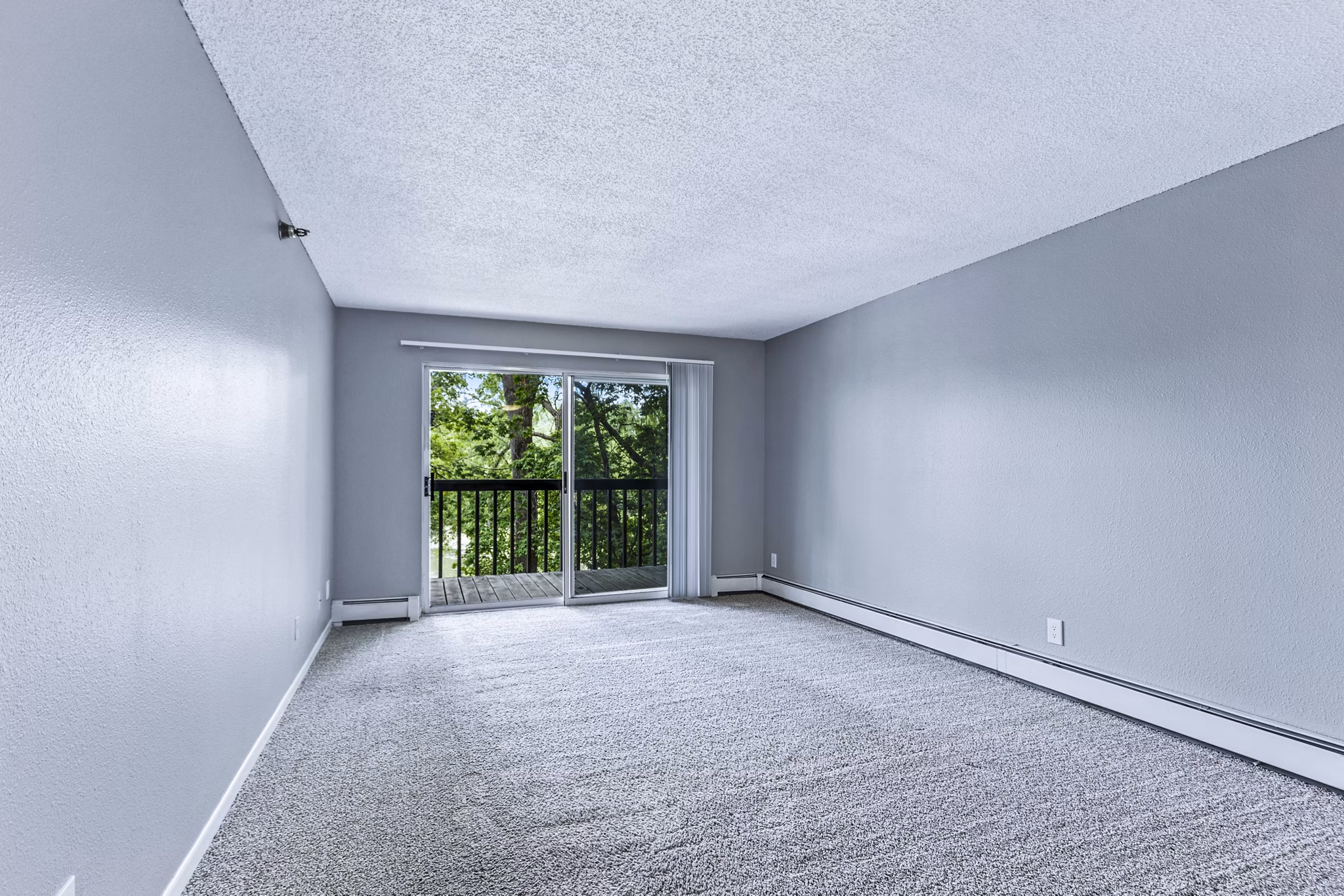 Spacious living room with modern decor and large windows in Avana West Park Apartments