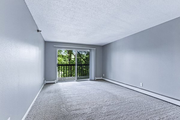 Spacious living room with modern decor and large windows in Avana West Park Apartments