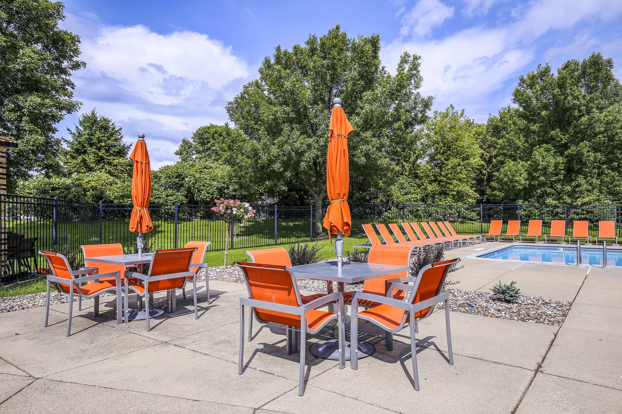 Pool patio area with contemporary seating at Avana West Park Apartments, ideal for relaxation and social gatherings