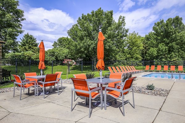 Pool patio area with contemporary seating at Avana West Park Apartments, ideal for relaxation and social gatherings