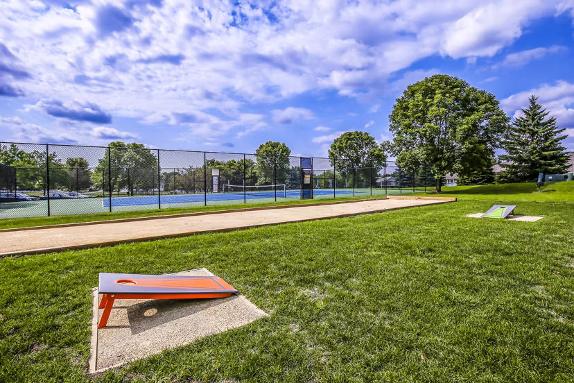 Outdoor sport courts at Avana West Park Apartments featuring basketball and tennis facilities for active living enthusiasts