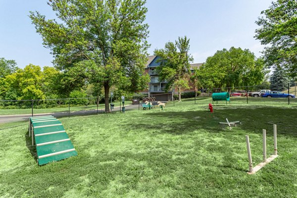 Fenced dog park with agility equipment at Avana West Park Apartments, ideal for pet-friendly living in modern luxury community