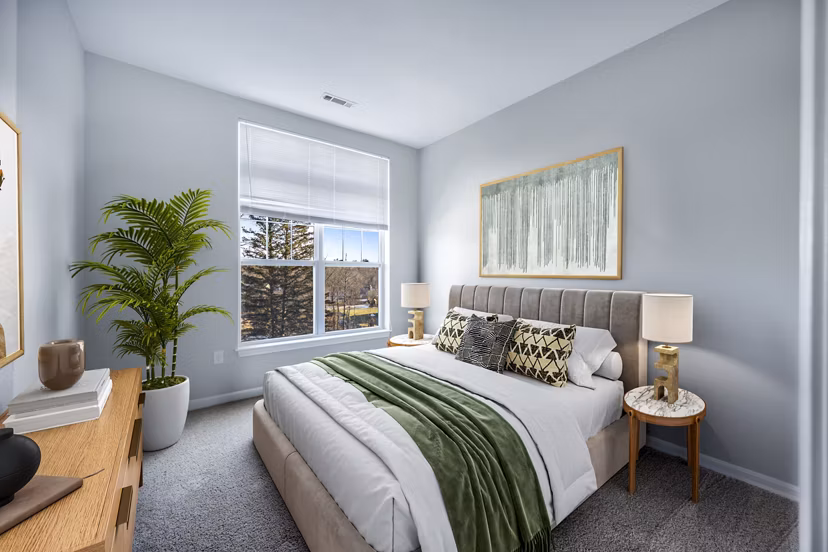 Cozy bedroom with modern furnishings at Marquee at Andover Apartments, offering luxury living spaces for residents seeking comfort and style
