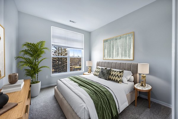 Cozy bedroom with modern furnishings at Marquee at Andover Apartments, offering luxury living spaces for residents seeking comfort and style