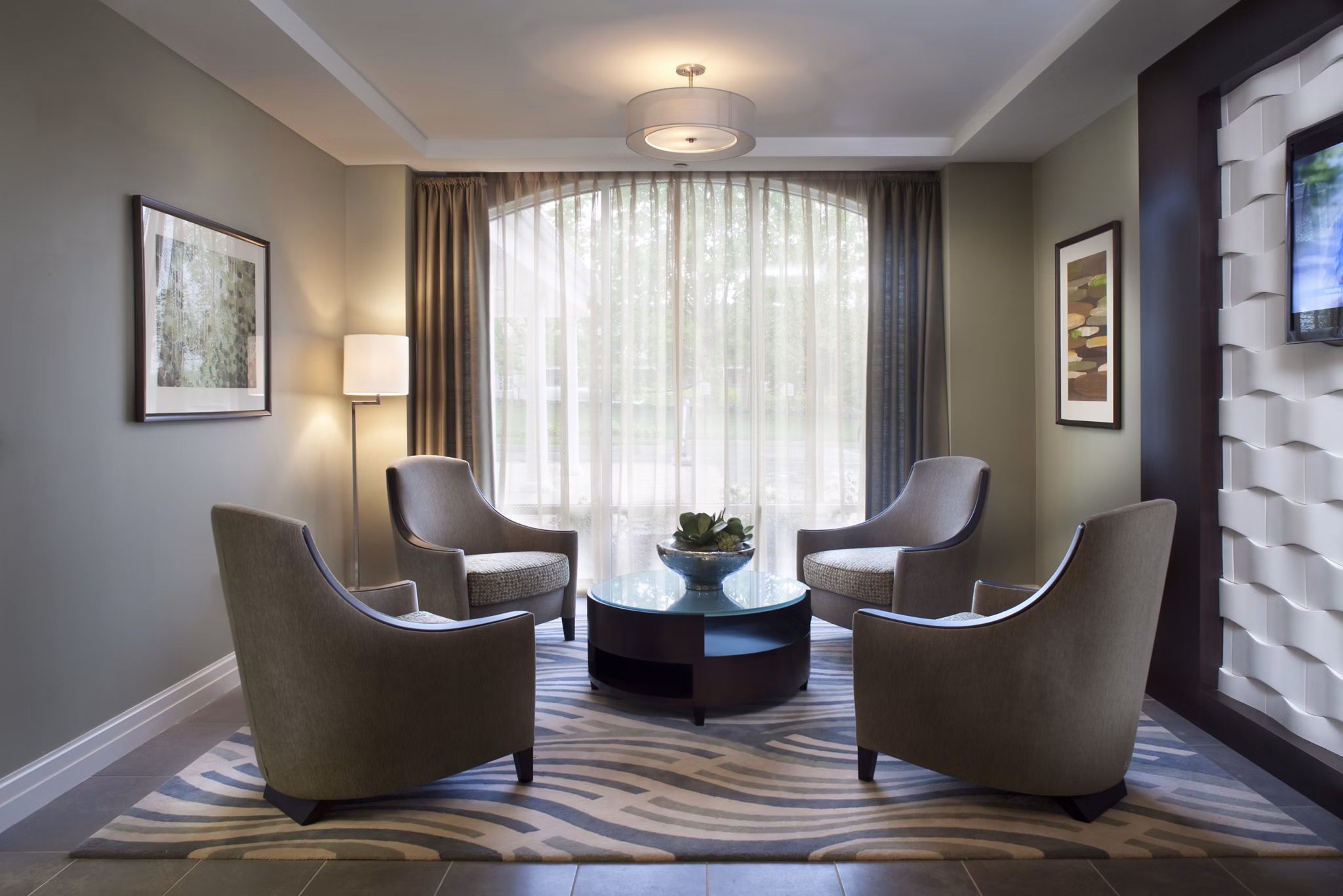 Clubhouse featuring modern lounge seating and community spaces at Marquee at Andover Apartments