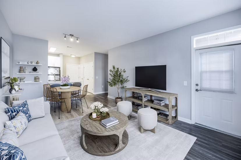 Living room featuring stylish furniture and large windows at Marquee at Andover Apartments