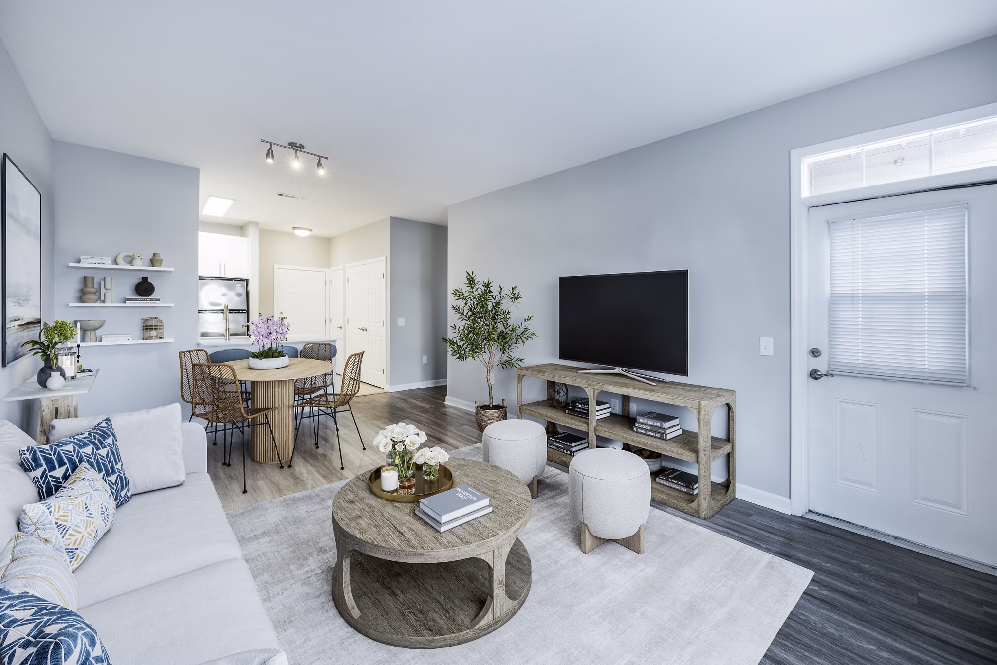Living room featuring stylish furniture and large windows at Marquee at Andover Apartments