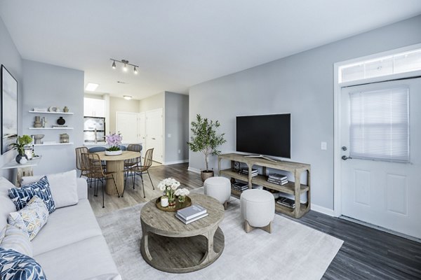 Living room featuring stylish furniture and large windows at Marquee at Andover Apartments