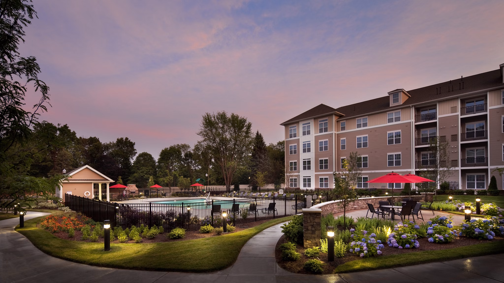 Resort-style pool at Marquee at Andover Apartments with shaded lounge areas and poolside seating