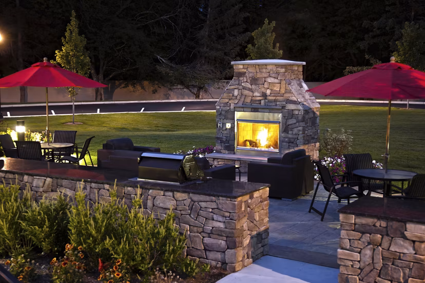 Modern fire pit lounge at Marquee at Andover Apartments, perfect for outdoor gatherings and relaxation in a luxurious setting
