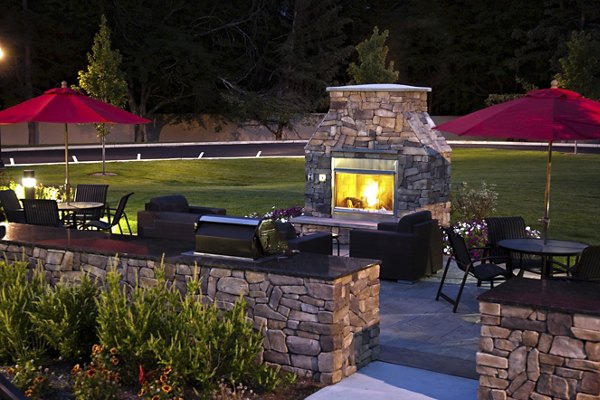 Modern fire pit lounge at Marquee at Andover Apartments, perfect for outdoor gatherings and relaxation in a luxurious setting